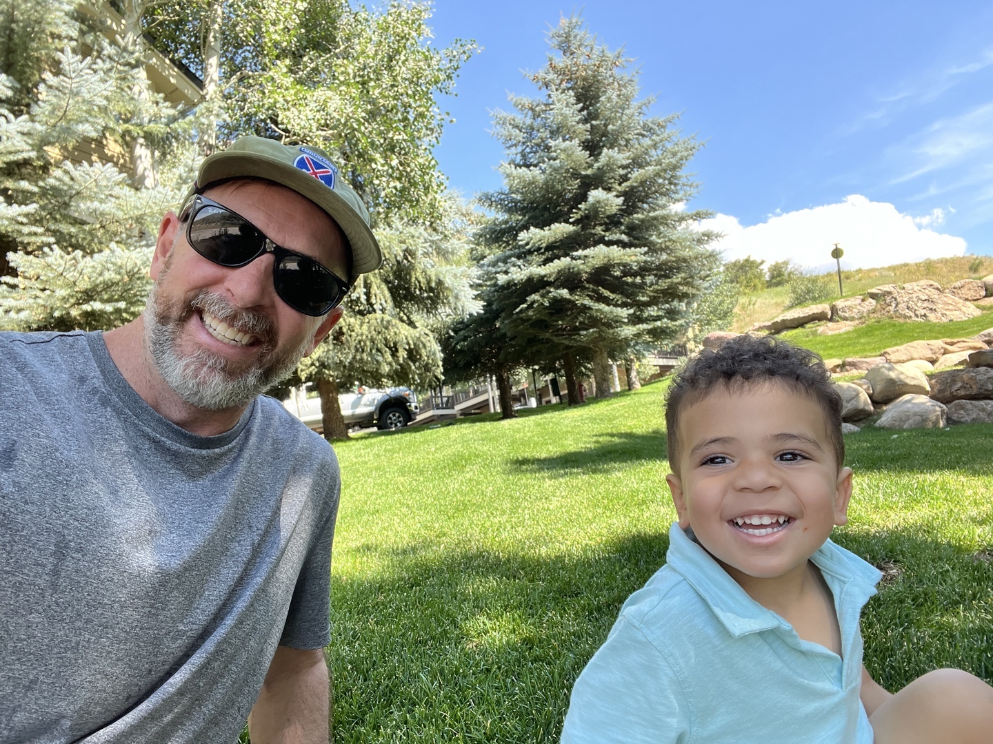 Padrick enjoying a sunny day outdoors with a young child